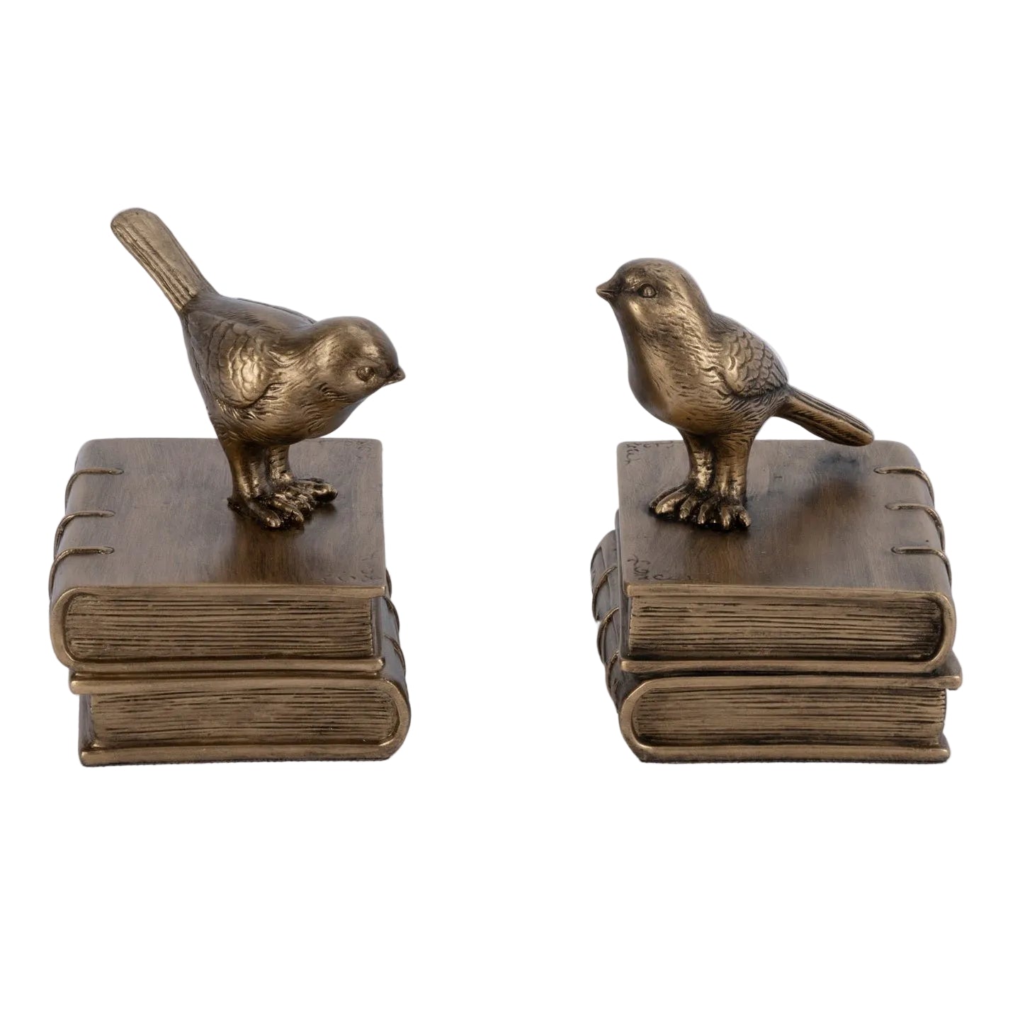 Two bronze bird sculptures on books against a white background