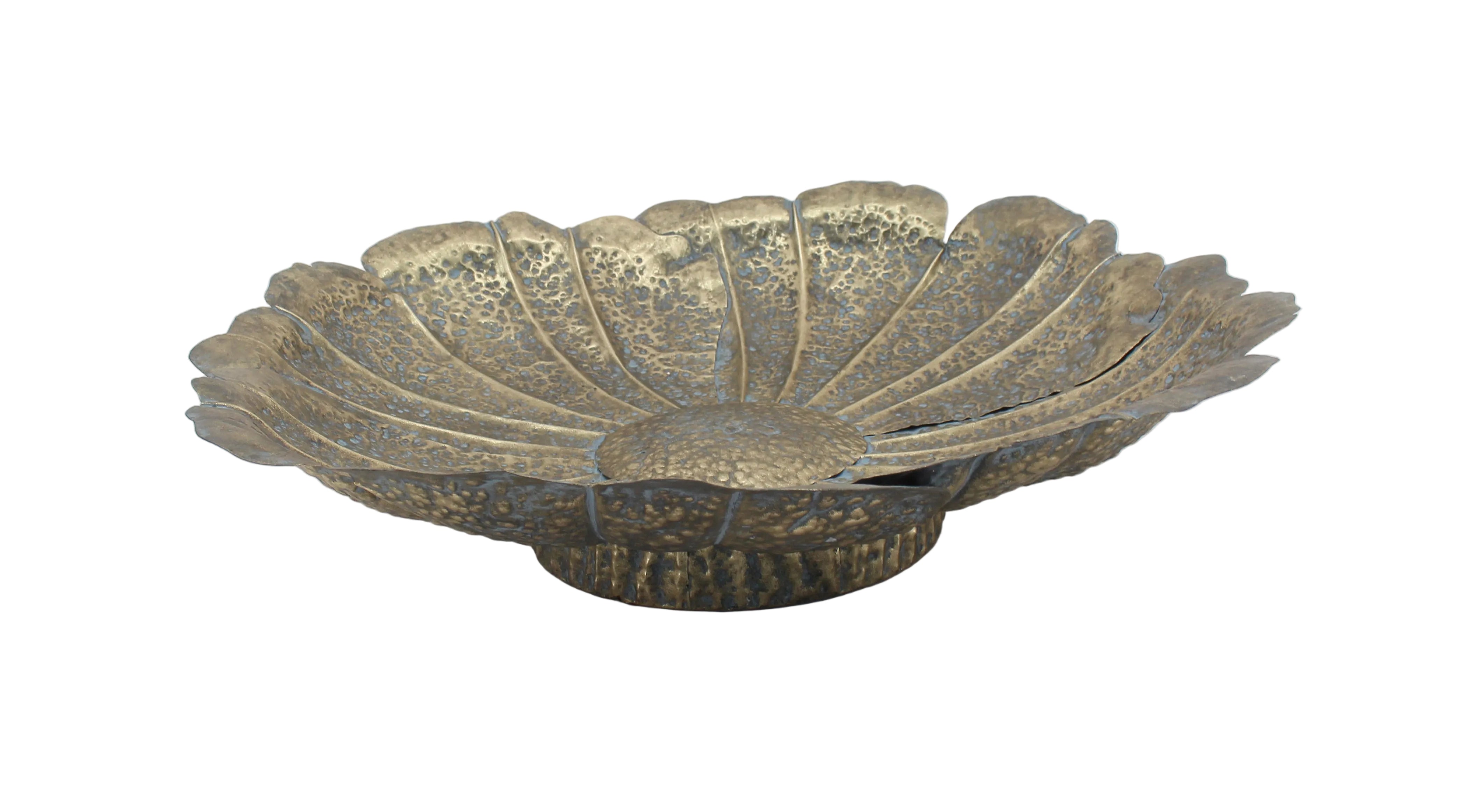 Decorative metal bowl with leaf-like design on a white background