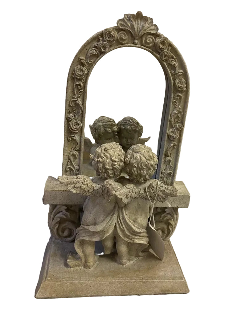 An ornate tabletop mirror with a decorative frame and sculpted cherub figures at the base