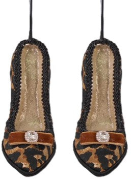 These are hanging Christmas ornaments: A pair of pointed-toe high heal shoes with a black and brown leopard print pattern, a gold glitter insole, and a brown strap with a rhinestone embellishment.