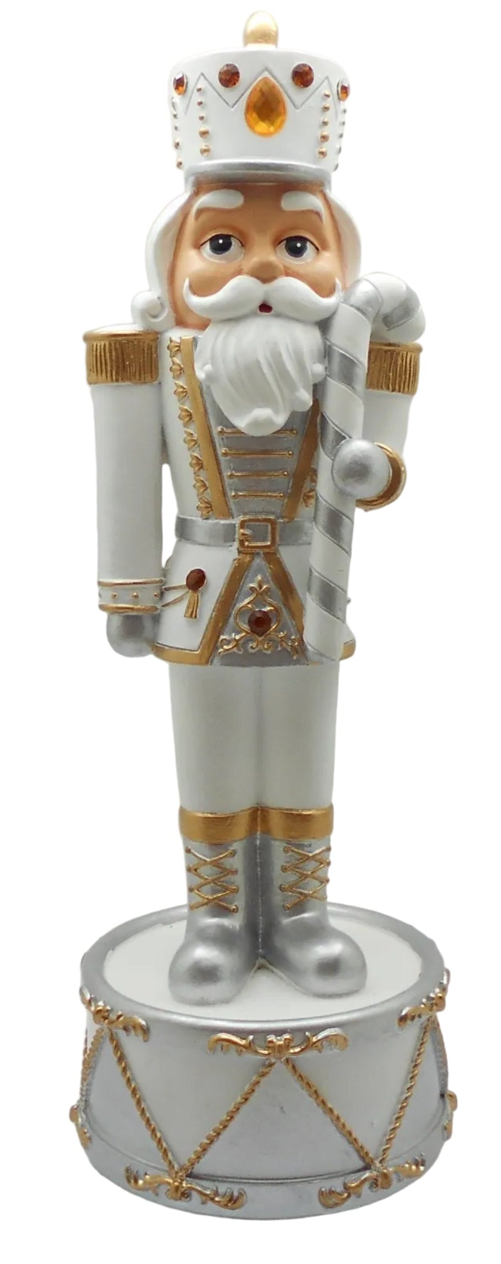 A white nutcracker music box with a gold and silver design, and red jewel accents, holding a silver and white candy cane.