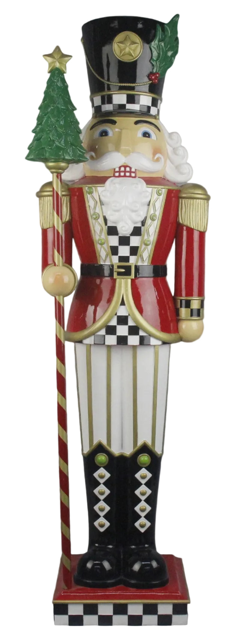 A traditional style nutcracker figurine with a red jacket, black & White checked shirt, white pants with gold stripes and black boots, with a Christmas tree on the stick