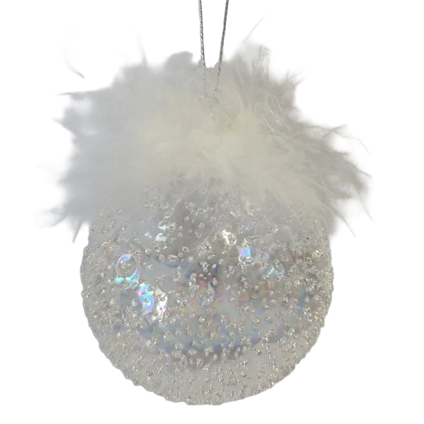 A clear glass Christmas ornament decorated with iridescent rhinestones and topped with fluffy white feathers, hanging by a thin silver string.