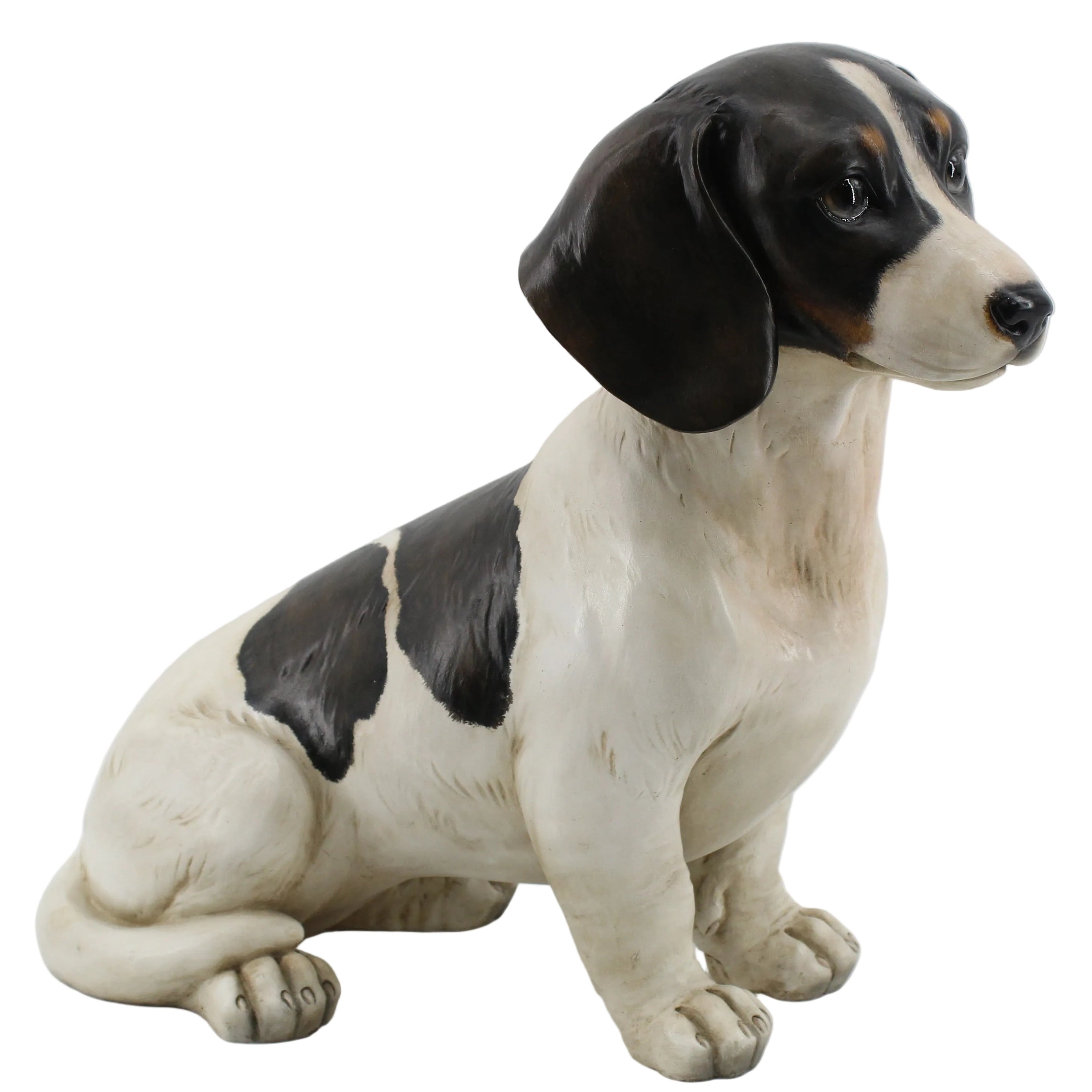 A ceramic figurine of a sitting black and white Jack Russel dog.