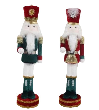 Two holiday ornaments depicting green and red soldiers with white beards and red hats, standing on round bases with gold trim.