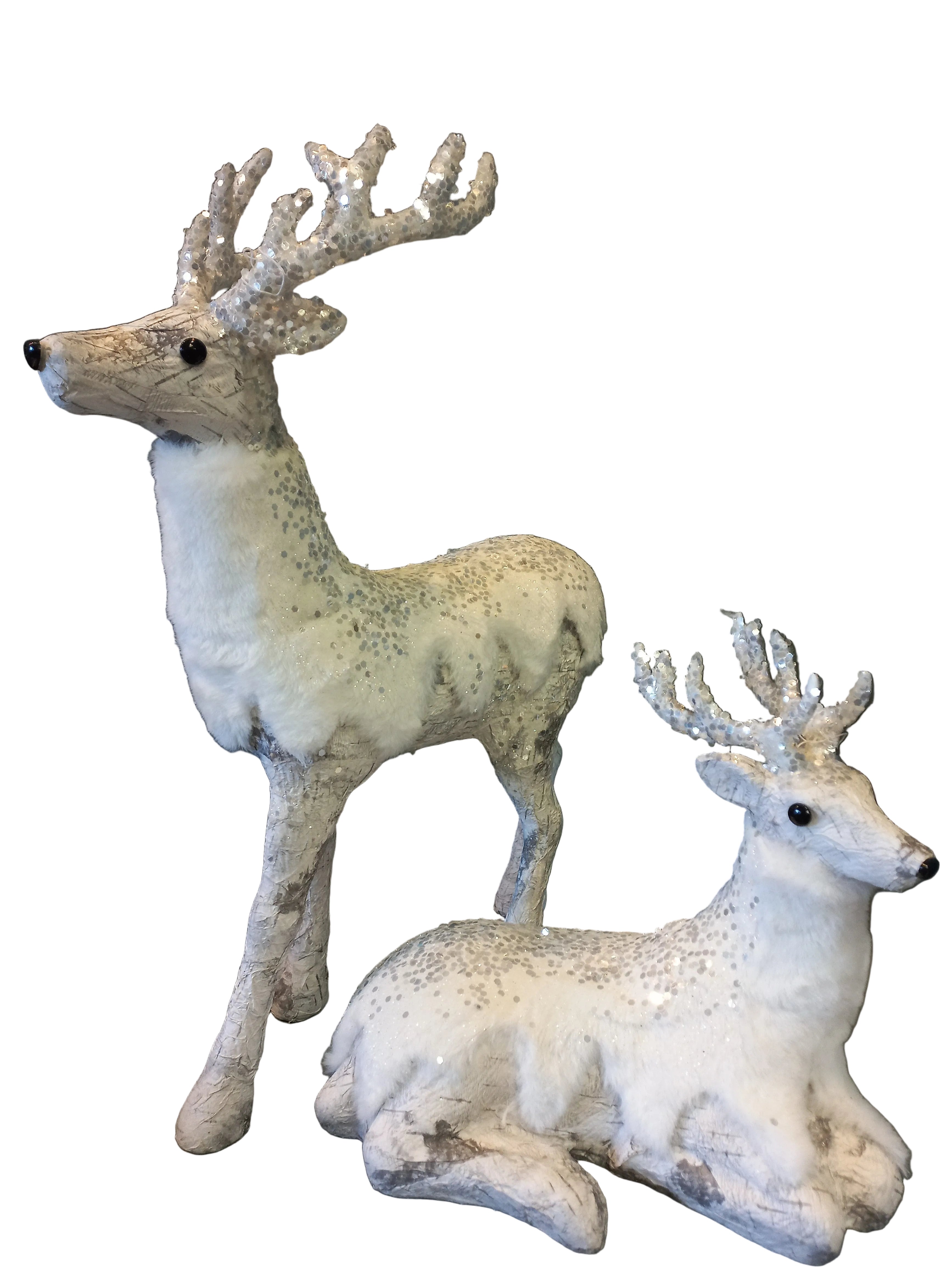 Two white fur deer ornaments, one standing and one lying down, with antlers and a glittery coating.