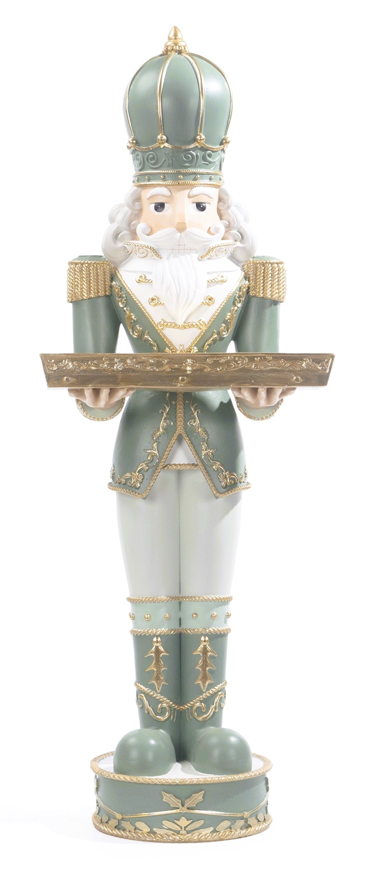 A ceramic nutcracker figurine dressed in a green and white uniform with gold trim, holding a tray.
