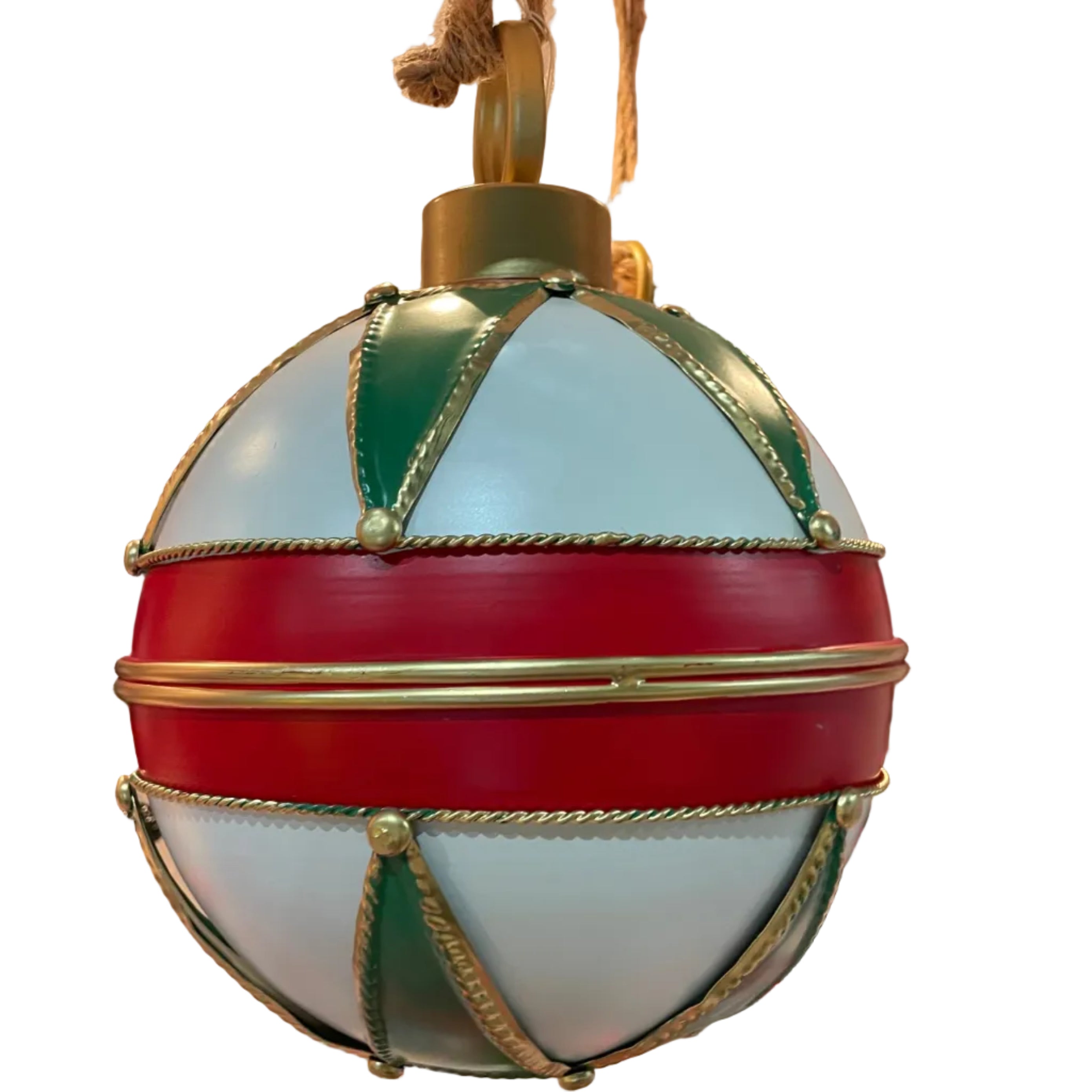 A large metal Christmas ornament featuring a white body with bold red horizontal bands, green geometric panels, and gold rope trim details.