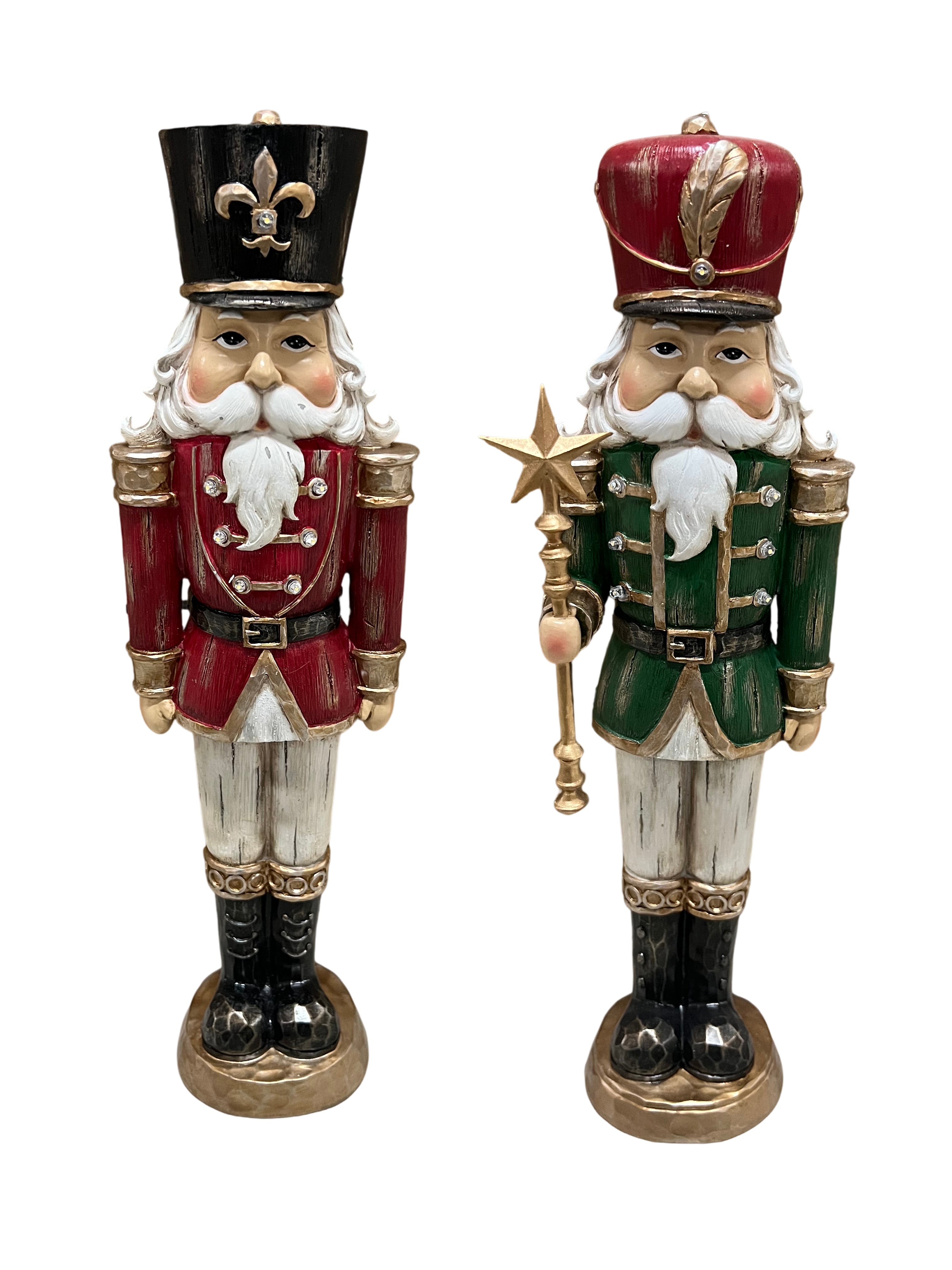 Two traditional Christmas nutcracker figurines standing side by side on a white background. One nutcracker wears a red coat, white beard, black hat with gold fleur-de-lis, and black boots.