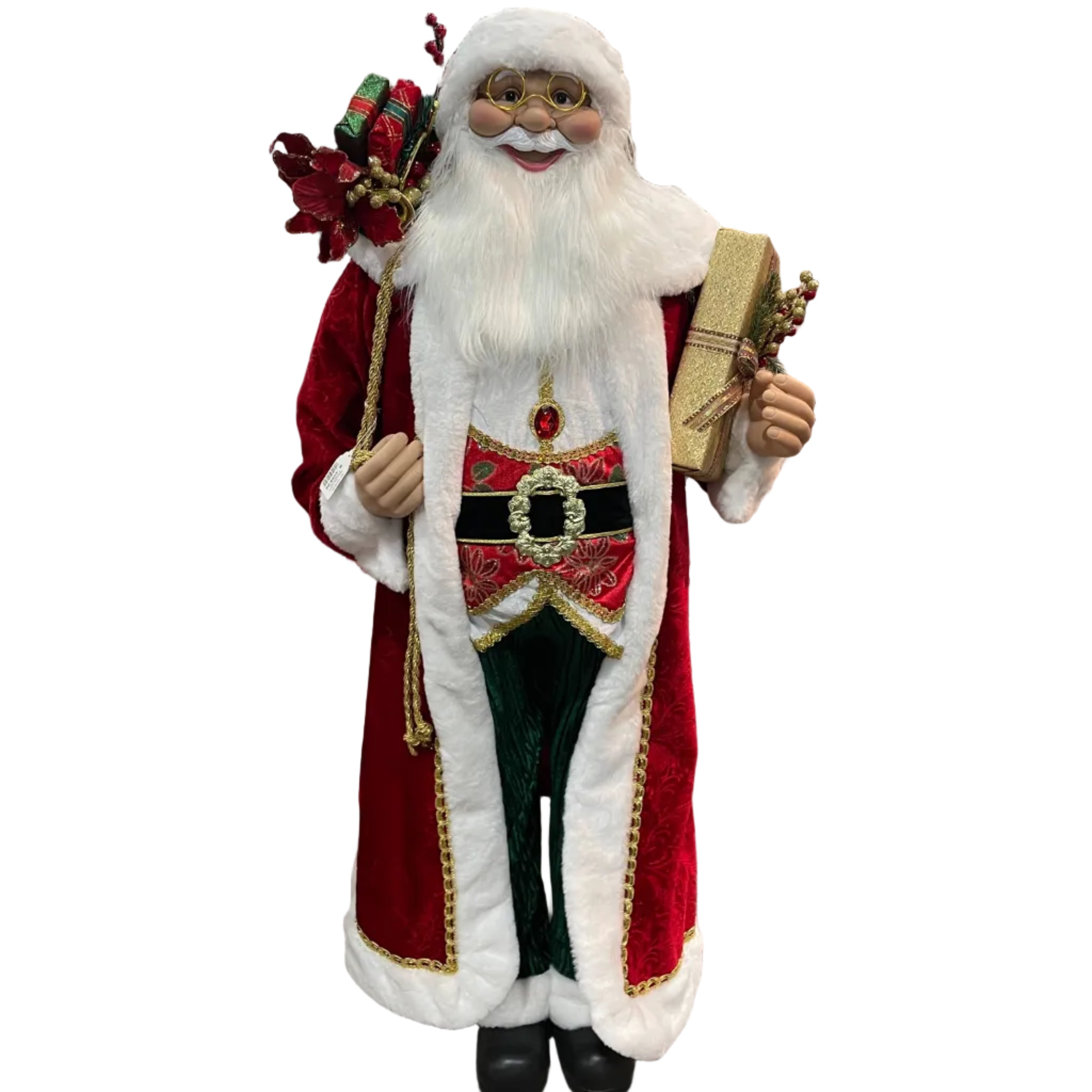 A life-size Santa Claus Christmas decoration standing in a retail store. The Santa figure has a white beard, red coat with white fur trim, a black belt with a gold medallion, green trousers, and holds a glitter gold present and a present sack.