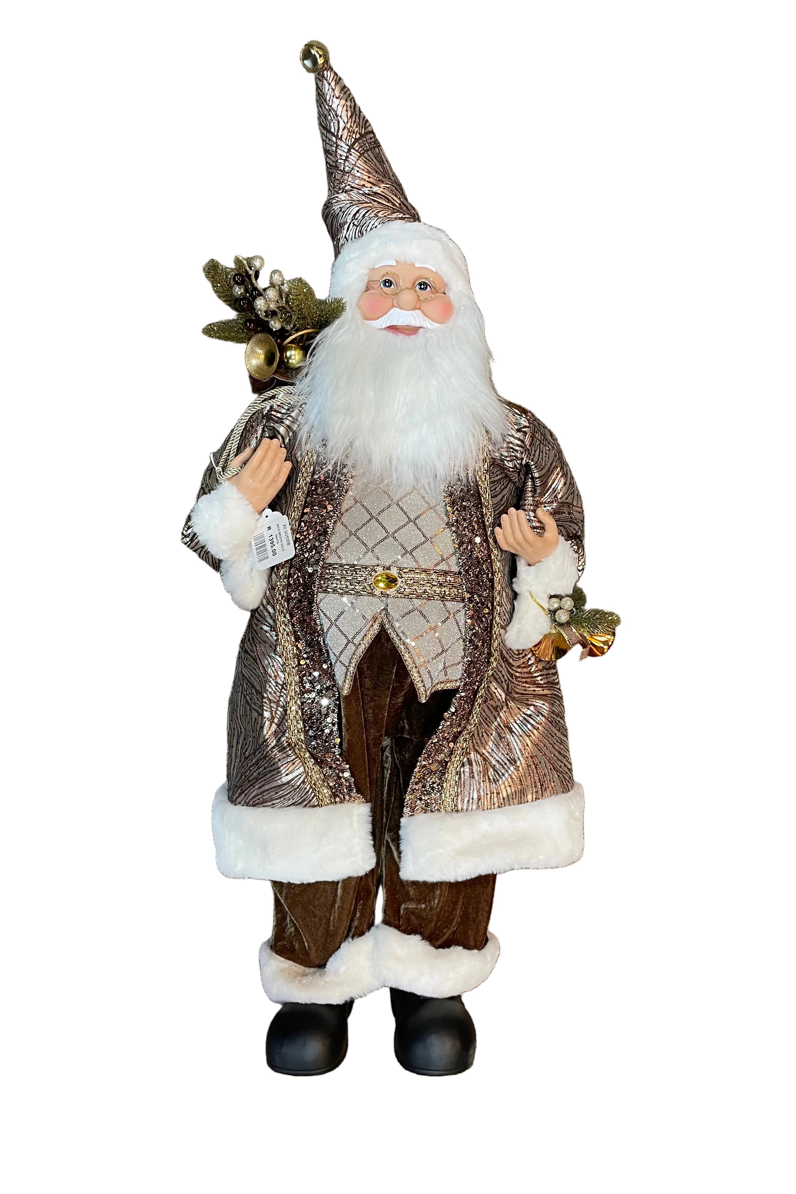 A festive Santa Claus figurine or decorative doll standing. The Santa has a long white beard, a patterned brown and metallic gold coat with white faux-fur trim, brown pants, black boots, and holds small gold bells and a Christmas present bag.