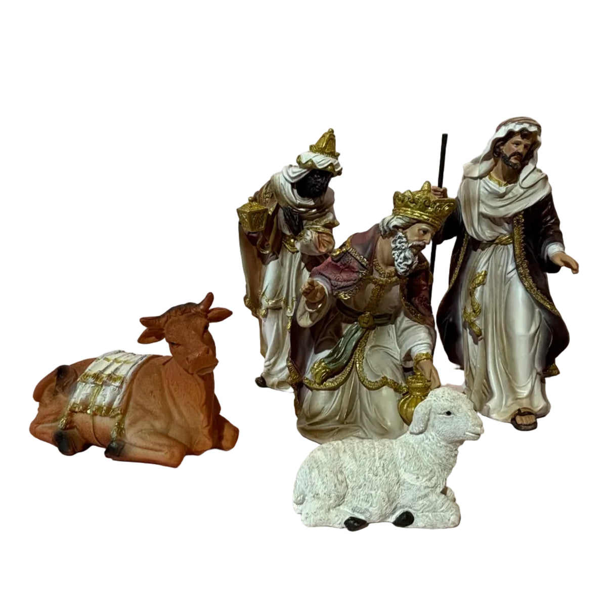 A small nativity figurine seT, including a brown cow, a white sheep, and several robed figures with gold and white detailing.