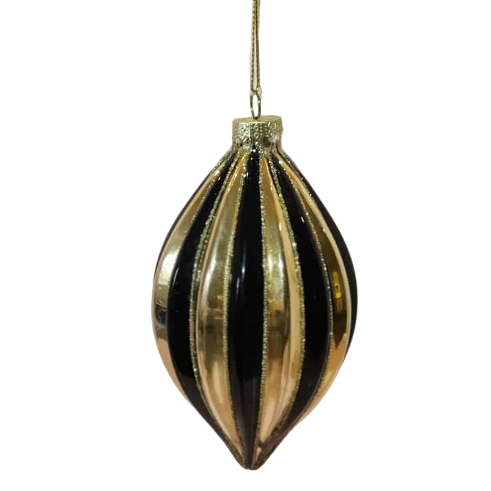 A gold and black striped glass Christmas ornament hanging from a thin gold string
