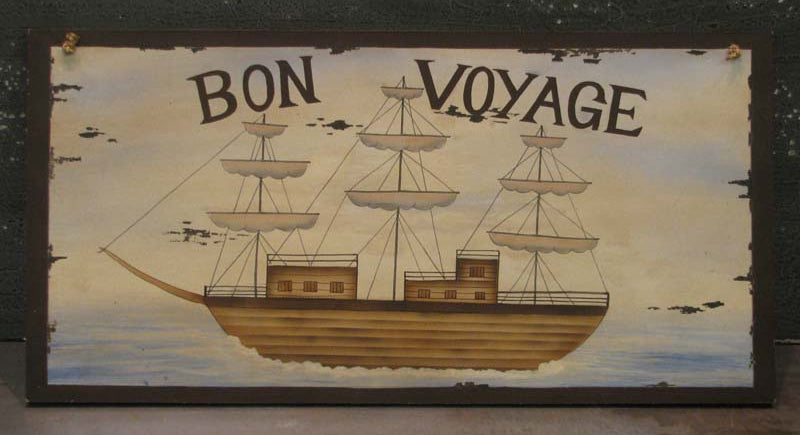 A decorative plaque with the text 'BON VOYAGE' on it, depicting an illustration of a sailing ship.