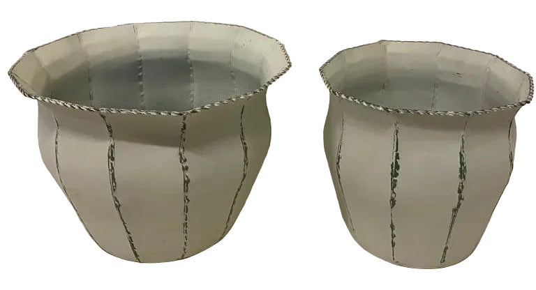 Two metal flower pots, one larger than the other, with a white and green color scheme and vertical green stripes.